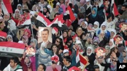 Supporters of Syria's President Bashar al-Assad shout slogans in Syria's northern city of Aleppo, March 27, 2011