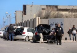 Passengers are seen after being evacuated at Mitiga airport in Tripoli, Libya, April 8, 2019.
