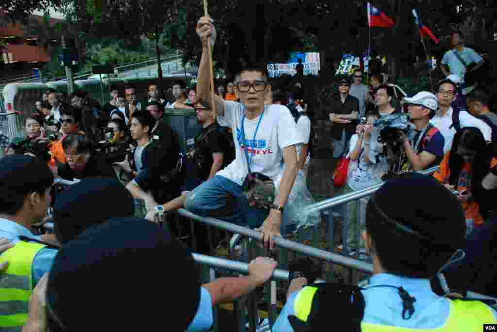 A senior protester faces off with police.