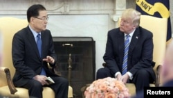 South Korea's national security chief Chung Eui-yong briefs U.S. President Donald Trump at the Oval Office about his visit to North Korea, in Washington, March 8, 2018.