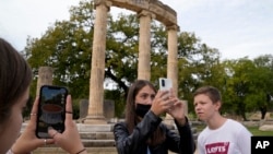 School students use a mobile app at the ancient site of Olympia, southwestern Greece, Wednesday, Nov. 10, 2021. (AP Photo/Thanassis Stavrakis)