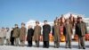 North Korean leader Kim Jong-Un (4th R) and officials attend a wreath-laying ceremony in front of a statue of North's founder Kim Il-Sung and his son and late leader Kim Jong-Il at the Mangyongdae Revolutionary School in Pyongyang on the occasion of birth anniversary of the late leader Kim Jong-Il, which falls on Saturday, in this undated recent picture released by the North's official KCNA news agency on February 16, 2013. 