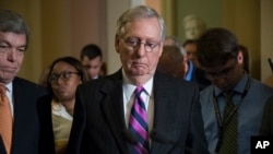 Senate Majority Leader Mitch McConnell of Kentucky, joined by Sen. Roy Blunt, R-Mo., left, pauses as he holds his first news conference since the Republican health care bill collapsed last week, Aug. 1, 2017, on Capitol Hill.