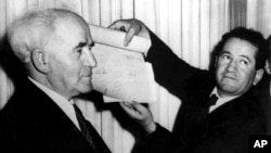 FILE - In this May 14, 1948 file photo, an official shows the signed document which proclaims the establishment of the new Jewish state of Israel declared by Prime Minister David Ben-Gurion in Tel Aviv, Israel.