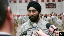 FILE - U.S. Army Capt. Tejdeep Singh Rattan speaks to journalists at Fort Sam Houston in San Antonio, March 22, 2010. Rattan was the first Sikh allowed to complete officer basic training while wearing the traditional turban and full beard since the Army altered its dress code. The New York City police have now adopted a similar dress policy.