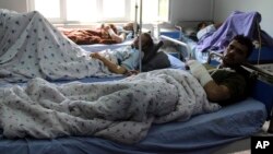 Injured men receive treatment at a hospital after a clash between Taliban and security forces in Kunduz province, Afghanistan, April 13, 2019.