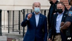 Democratic presidential candidate former Vice President Joe Biden speaks to member of the media as he leaves St. Joseph Catholic Church, Oct. 3, 2020, in Wilmington, Delaware.