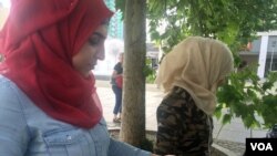 Syrian refugees who live in a camp about an hour and a half outside the city at a Dresden, Germany market, enjoying a day far from the camp they live in where anti-immigrant protesters hold demonstrations almost every week, July 7, 2016. (H. Murdock/VOA)