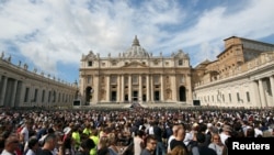 FILE - The faithful gather in front of St. Peter's Basilica as Pope Francis leads the Regina Coeli prayer in Saint Peter's Square at the Vatican, Sept. 17, 2017.