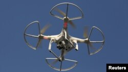 FILE - A drone is seen flying in Shenzhen, China, Dec. 18, 2015. Chinese online retailer JD.com Inc is developing drones that would allow long-distance deliveries of consumer goods and farm produce.