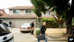 Police officers carry evidence bags from the family home of Gilroy Garlic Festival gunman Santino William Legan, July, 29, 2019, in Gilroy, Calif.