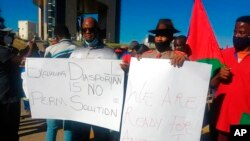 FILE - People protest in Windhoek, Namibia, May 28, 2021. Germany had just reached an agreement with Namibia to officially recognize as genocide the colonial-era killings of tens of thousands of people and commit to spending $1.3 billion, largely on development projects.