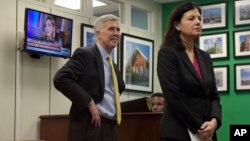 FILE - Supreme Court Justice nominee Neil Gorsuch and former New Hampshire Sen. Kelly Ayotte wait for a meeting with Sen. Chris Murphy, D-Conn. on Capitol Hill in Washington, Feb. 16, 2017.