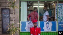  FILE - A security guard sits near a gate in Addis Ababa, Ethiopia, on October 10, 2016. A state of emergency in effect in Ethiopia since October 8 is being used broadly to silence critical media voices and lock up suspected dissidents, according to a range of reports coming in from the country.