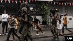 Anggota kelompok bersenjata M23 berjalan di antara warga di jalanan di wilayah Keshero, Goma, Republik Demokratik Kongo, pada 27 Januari 2025. (Foto: AFP/STR)