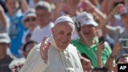 FILE - Pope Francis arrives for his weekly general audience in St. Peter's Square, Aug. 26, 2015.