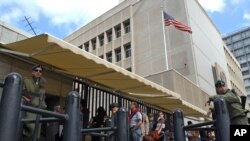 FILE - In this March 17, 2003 file photo, an Israeli border policemen guards the U.S. Embassy in Tel Aviv.