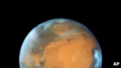 This May 12, 2016 image provided by NASA shows the planet Mars. (NASA/ESA/Hubble Heritage Team - STScI/AURA, J. Bell - ASU, M. Wolff - Space Science Institute via AP)