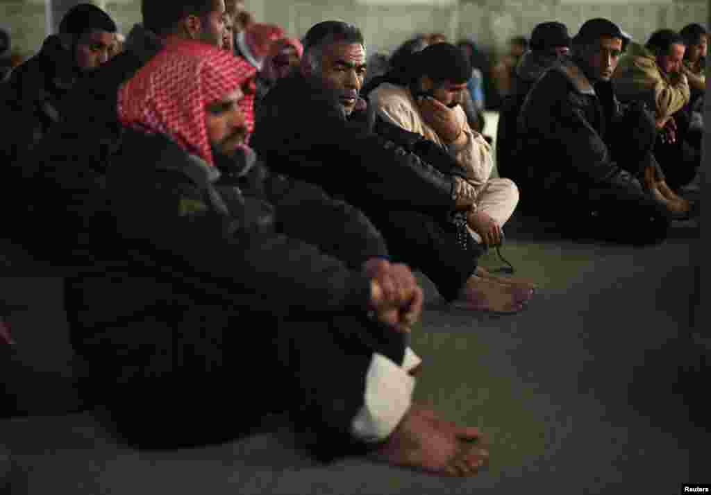 Mourners react at a mosque during the funeral of a three-year-old Palestinian girl, who medics said was killed by shrapnel from an Israeli strike, in the central Gaza Strip, Dec. 25, 2013.
