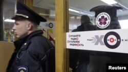 Policemen work inside the office of Russian radio station Ekho Moskvy, after an intruder attacked the station's anchor Tatyana Felgengauer in Moscow, Russia, Oct. 23, 2017. 