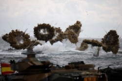 FILE - Amphibious assault vehicles of the South Korean Marine Corps fire smoke bombs during a U.S.-South Korea joint landing operation drill as a part of the two countries' annual military training in Pohang, South Korea, April 2, 2017.