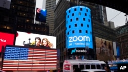 FILE - The Zoom logo is shown outside the Nasdaq Stock Market ahead of its initial public offering, April 18, 2019, in New York. 