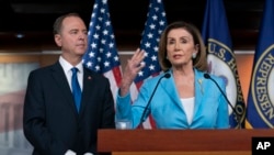 FILE - Speaker of the House Nancy Pelosi is joined by House Intelligence Committee Chairman Adam Schiff at a news conference as House Democrats move ahead in the impeachment inquiry of President Donald Trump, at the Capitol, in Washington, Oct. 2, 2019. 
