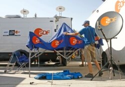 FILE - German television network ZDF crew members dismantle their setup in Marseille, July 18, 2007.