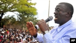 FILE - Uganda's main opposition leader and Inter Party flag bearer, Dr. Kiiza Besigye, addresses his supporters at Masaka Lyantonde, about 200 kms west of Kampala capital Uganda. Saturday, Nov. 6, 2010.