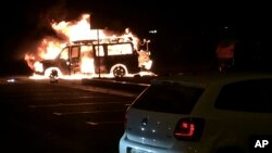 A van burns after an explosion near the regional administration building in Donetsk, eastern Ukraine, June 12, 2014.