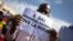 FILE - A man holds up a sign reading "Down with Emmanuel Macron, long live Russia," during a rally in Bamako, Mali, Jan. 14, 2022, against former colonial power France, which still maintains a military presence in Mali.