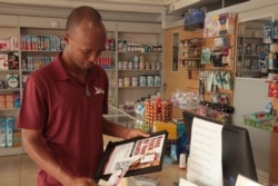 Andrew Quao, a co-founder of the healthcare tech startup, Red Bird works with pharmacies across Ghana, Nov. 13, 2019. (Stacey Knott/VOA)