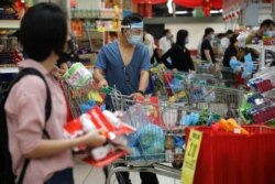 People line up to pay at a supermarket, amid the coronavirus disease outbreak in Kuala Lumpur, Malaysia, Jan. 12, 2021.