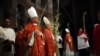 Christian clergymen carry palm fronds during the Palm Sunday procession in the Church of the Holy Sepulcher, traditionally believed by many to be the site of the crucifixion, in Jerusalem's Old City, March 20, 2016.