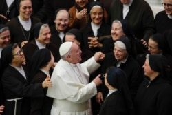 FILE - Pope Francis greets a group of nuns during his weekly general audience, in Paul VI Hall at the Vatican, Jan. 15, 2020.