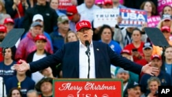 FILE - President-elect Donald Trump speaks during a rally at the Ladd–Peebles Stadium in Mobile, Ala., Dec. 17, 2016. Trump has ruled out selling off his vast global business interests but has said he'll announce a plan next month to address business conflicts.