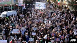 Pro-government demonstrators march in Iran's holy city of Qom, some 130 kilometres south of Tehran, on Jan. 3, 2018, as tens of thousands gathered across Iran in a massive show of strength for the Islamic rulers after days of deadly unrest.