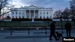 FILE - Secret Service Uniformed Division officers patrol in front of the White House, Washington, D.C., Jan. 20, 2015.