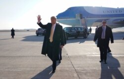 FILE - President Donald Trump waves to supporters upon his arrival in Colorado Springs, Colorado.