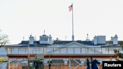 Des ouvriers construisent un stand d'observation devant la Maison Blanche pour la cérémonie d'investiture prévue le 20 janvier 2020 à Washington, aux États-Unis. Photo prise le 28 novembre 2020. 
