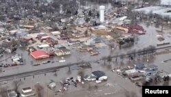 An aerial view of damaged buildings after a storm triggered historic flooding, in Valley, Nebraska, in this still image from a handout video taken March 16, 2019. 