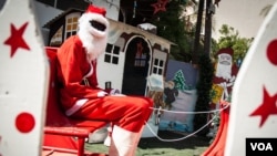 Abdou Khadre Diop, dressed as Santa Claus, waits for children to visit at Patisseries des Ambassades in Dakar, Senegal, Dec. 19, 2019. (Annika Hammerschlag/VOA)