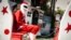 Abdou Khadre Diop, dressed as Santa Claus, waits for children to visit at Patisseries des Ambassades in Dakar, Senegal, Dec. 19, 2019. (Annika Hammerschlag/VOA)