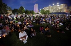 People with candles attend as immigration rights activists hold a "Lights for Liberty" candlelit vigil at Cleveland Square Park in El Paso, Texas, July 12, 2019.