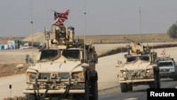 FILE - A convoy of U.S. military vehicles is seen at the Iraqi-Syrian border crossing, on the outskirts of Dohuk, Iraq, Oct. 21, 2019.