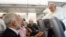 Pope Francis listens to journalist's question as he flies back to Rome following Brazil visit, July 29, 2013.