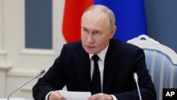 Russian President Vladimir Putin takes part in an exercise of Russia's strategic nuclear deterrence forces to train officials on operating nuclear weapons with practical launches of ballistic and cruise missiles, at the Kremlin in Moscow, Russia, Oct. 29, 2024. 