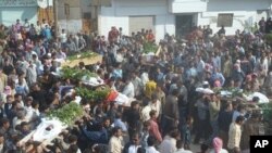 Anti-government protesters carry the coffins of Sunni Muslim villagers killed on Wednesday, in Hula near Homs November 2, 2011.