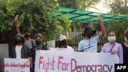 This handout photo taken and released by Dawei Watch on March 25, 2021 shows protesters holding banners as they take part in a demonstration against the military coup in Dawei. (Handout by Dawei Watch / AFP) 