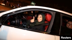A Saudi woman drives her car in her neighborhood, in Al Khobar, Saudi Arabia, June 24, 2018. 